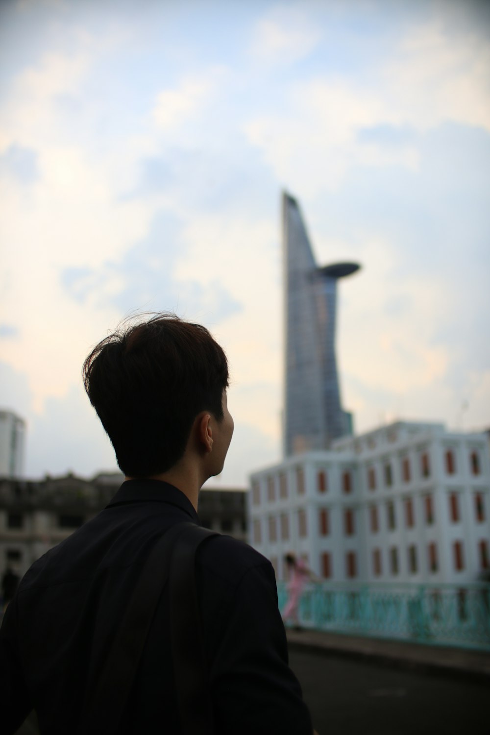 a man looking at a tall building