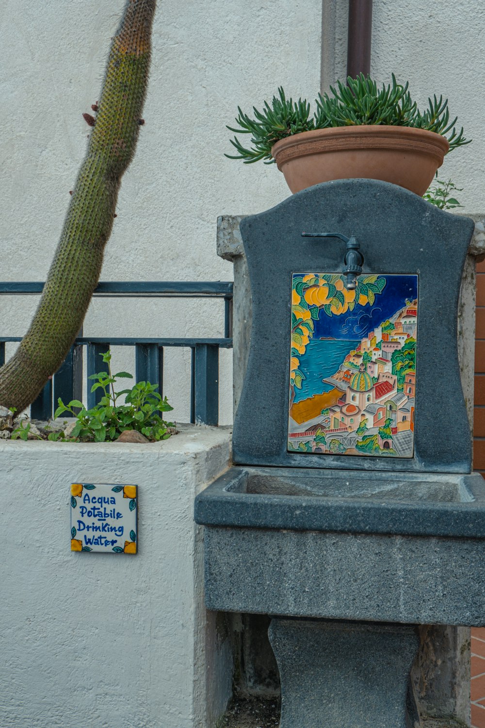 a blue trash can with a painting on it