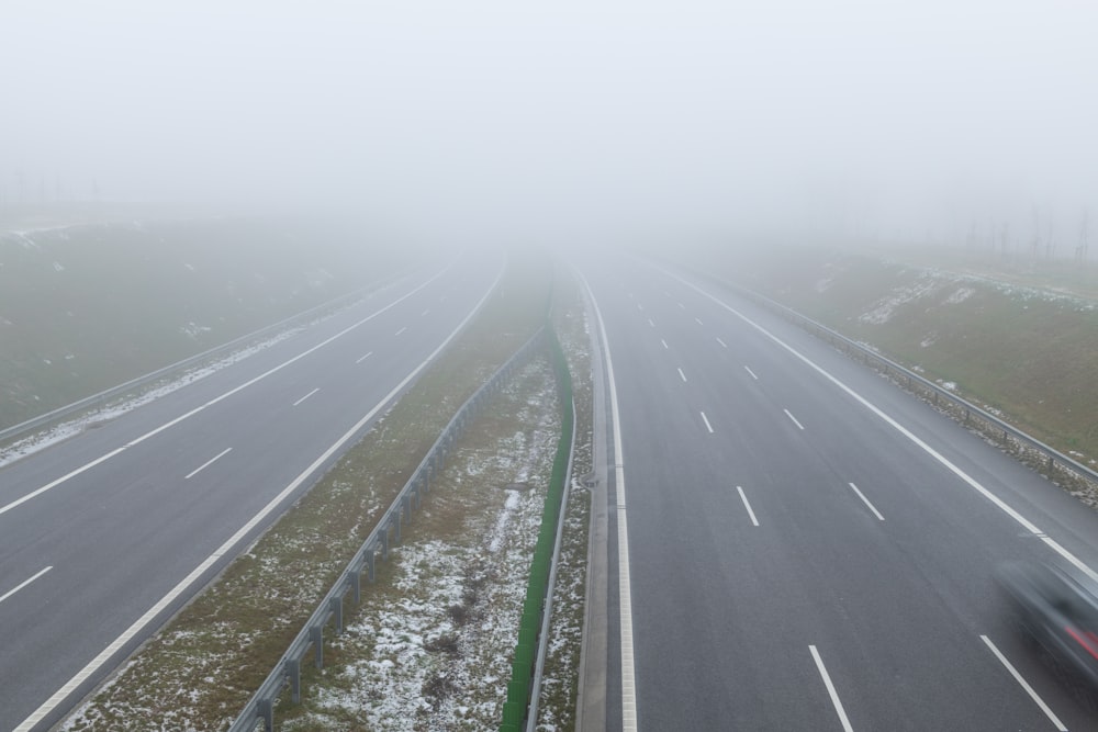 a road with fog on the side