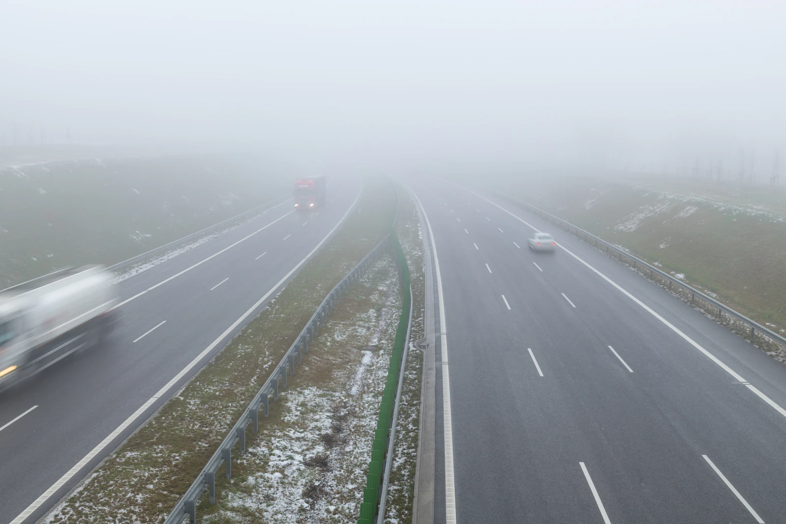 Cars travelling along Poland's S7 motorway in dense fog