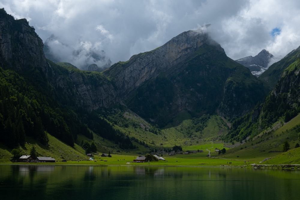 a body of water with mountains in the back