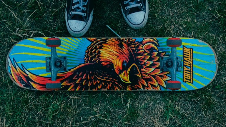 A sleek modern skateboard deck with vibrant graffiti art.