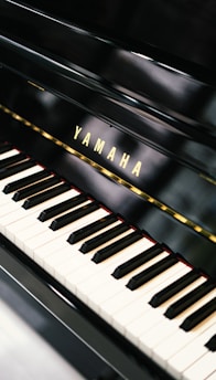 a yamaha piano with a black background