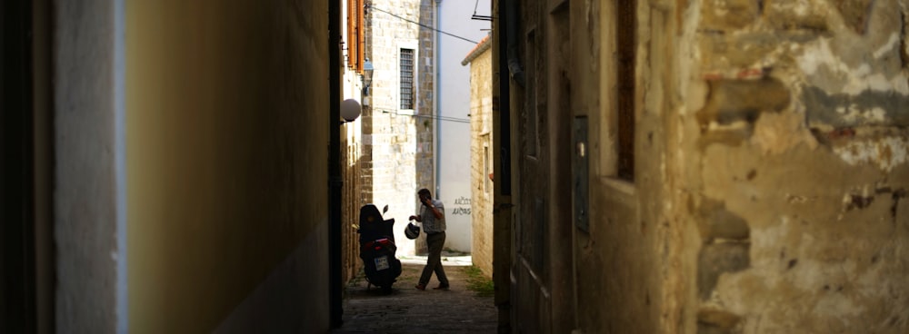 a person walking down a narrow alley