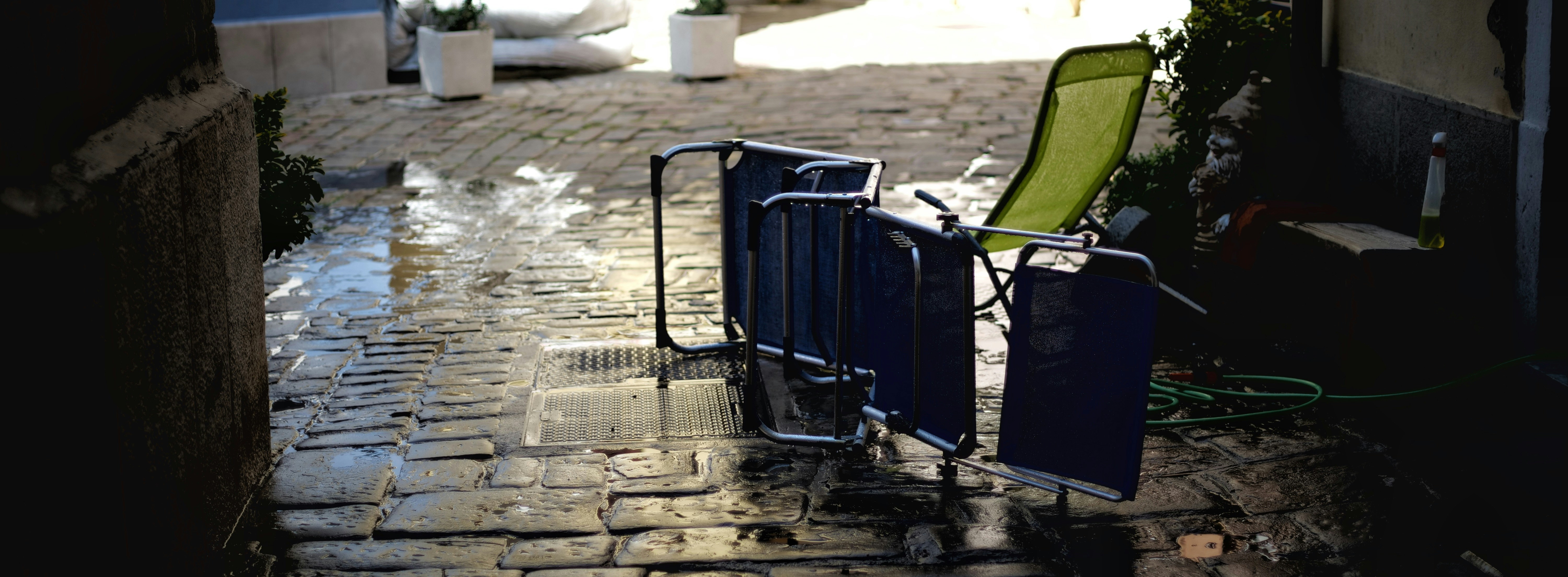 a row of chairs on a brick patio