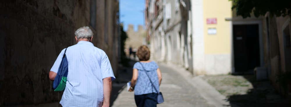 a man and woman walking down a street