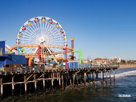 a ferris wheel on a pier with Santa Monica Pier in the background