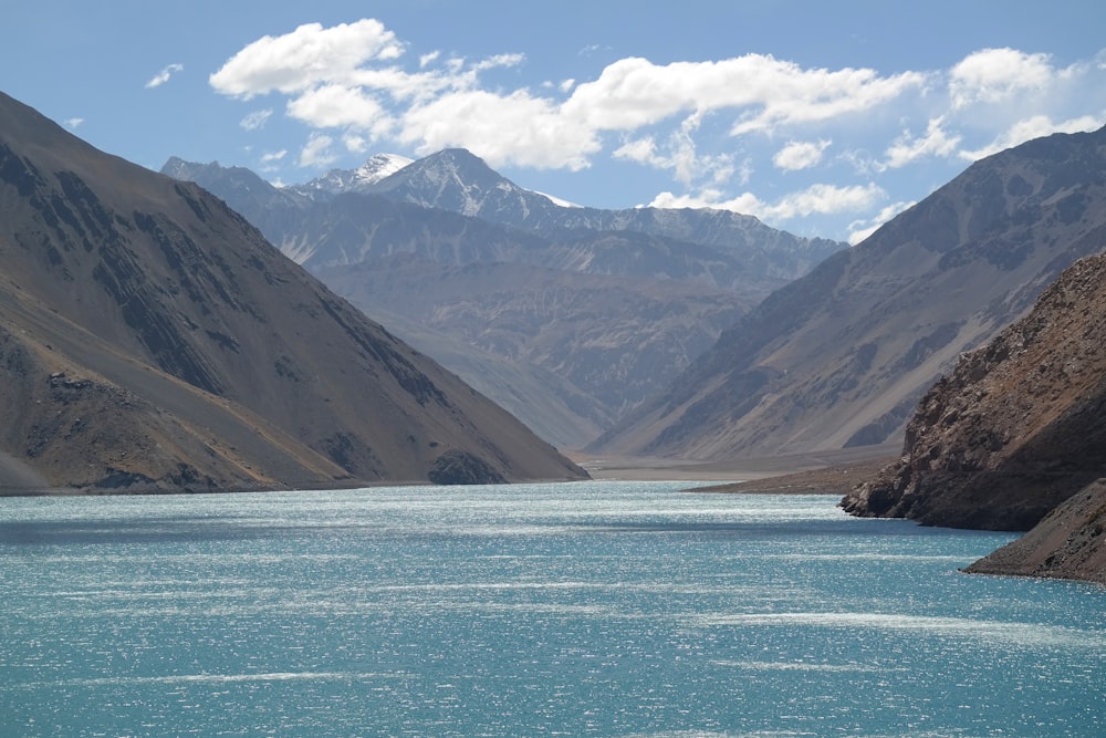 a body of water with mountains in the back