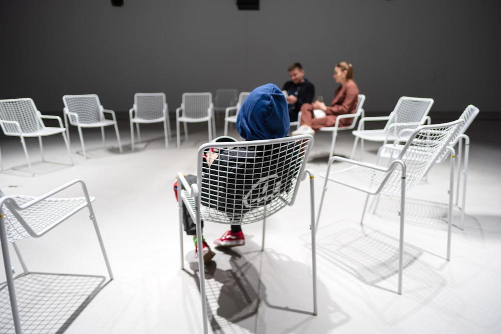 a couple of people sitting at a table with a basket and chairs