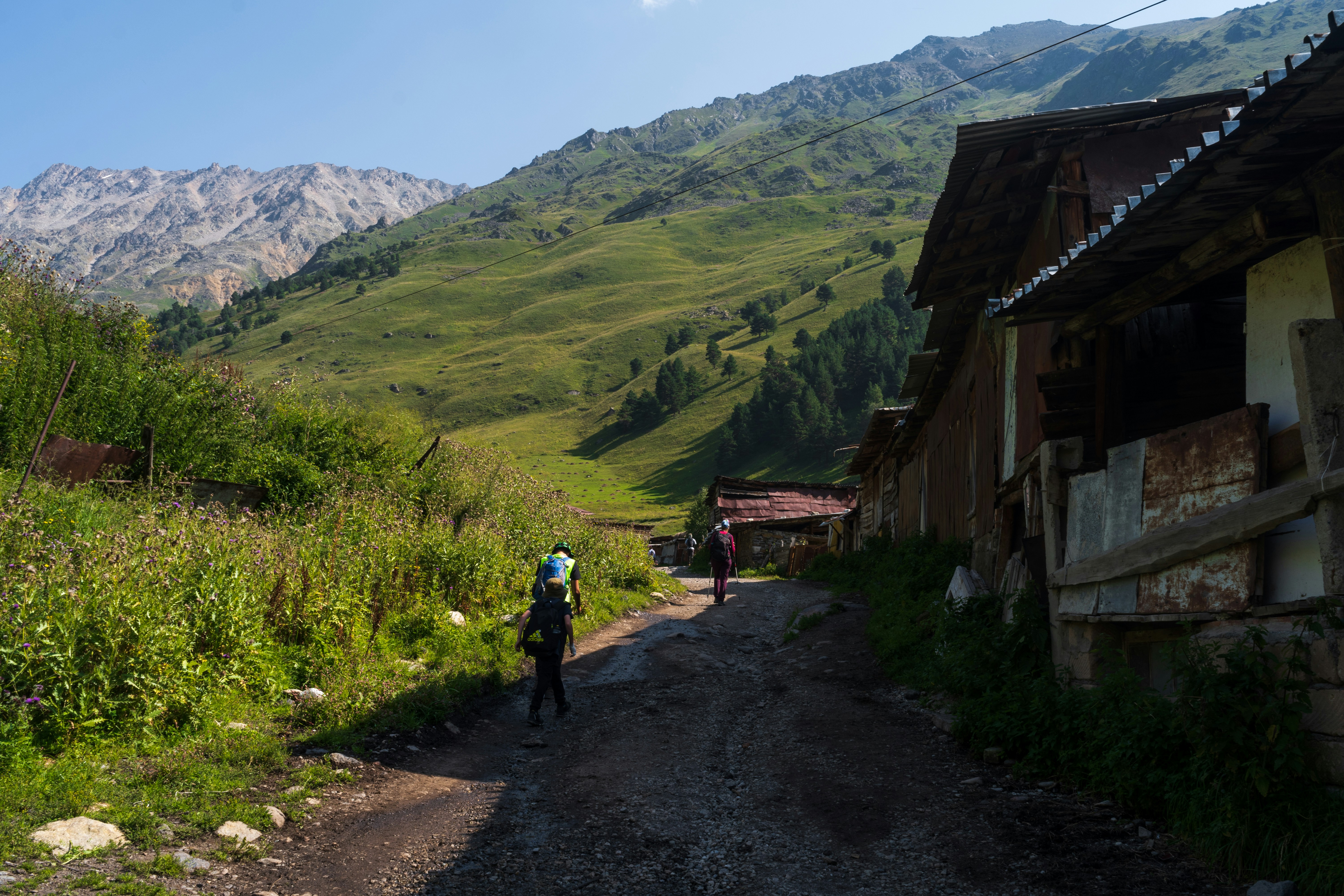 people walking on a dirt road