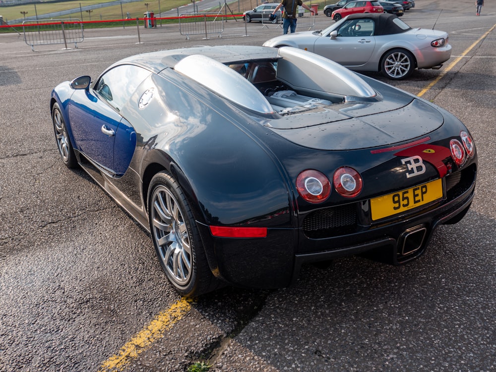 a black sports car parked in a parking lot