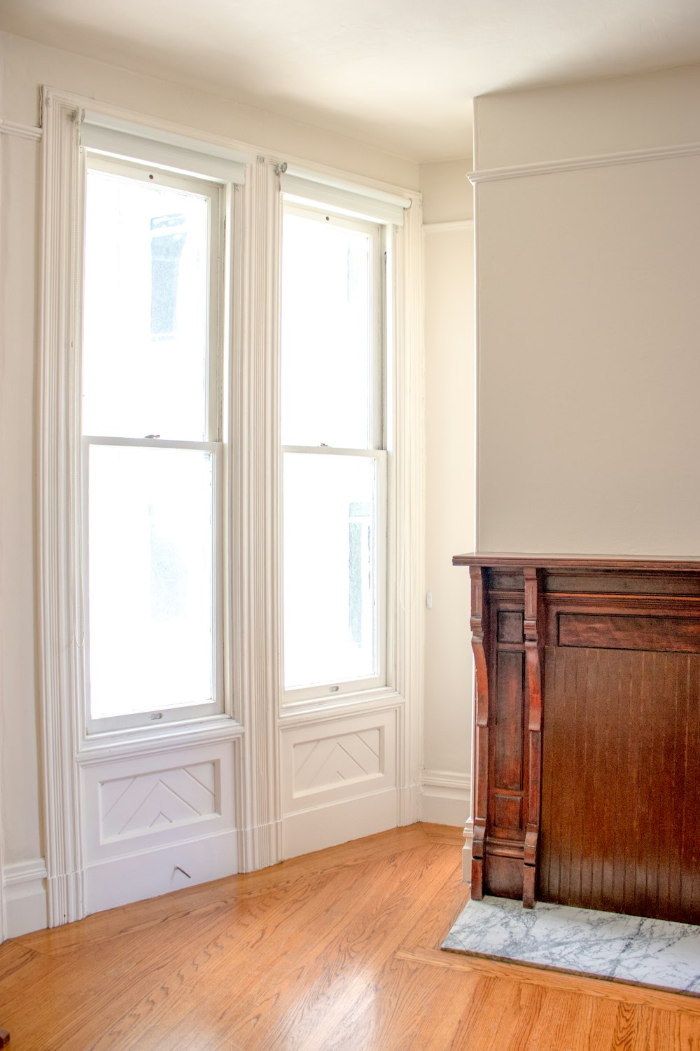 a room with a wood floor and a wood cabinet