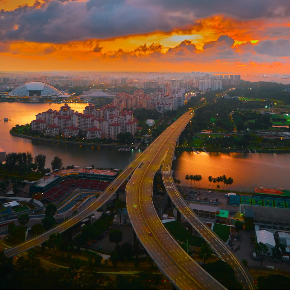 a road with a bridge and buildings on the side