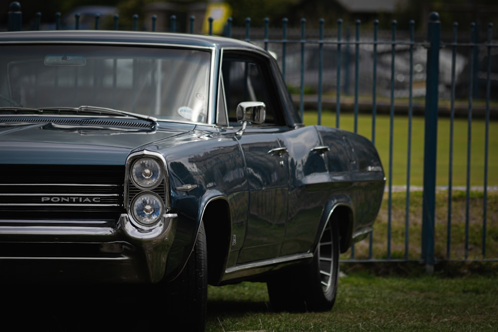 a black car parked on grass