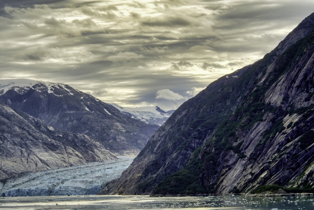 a body of water with mountains in the back