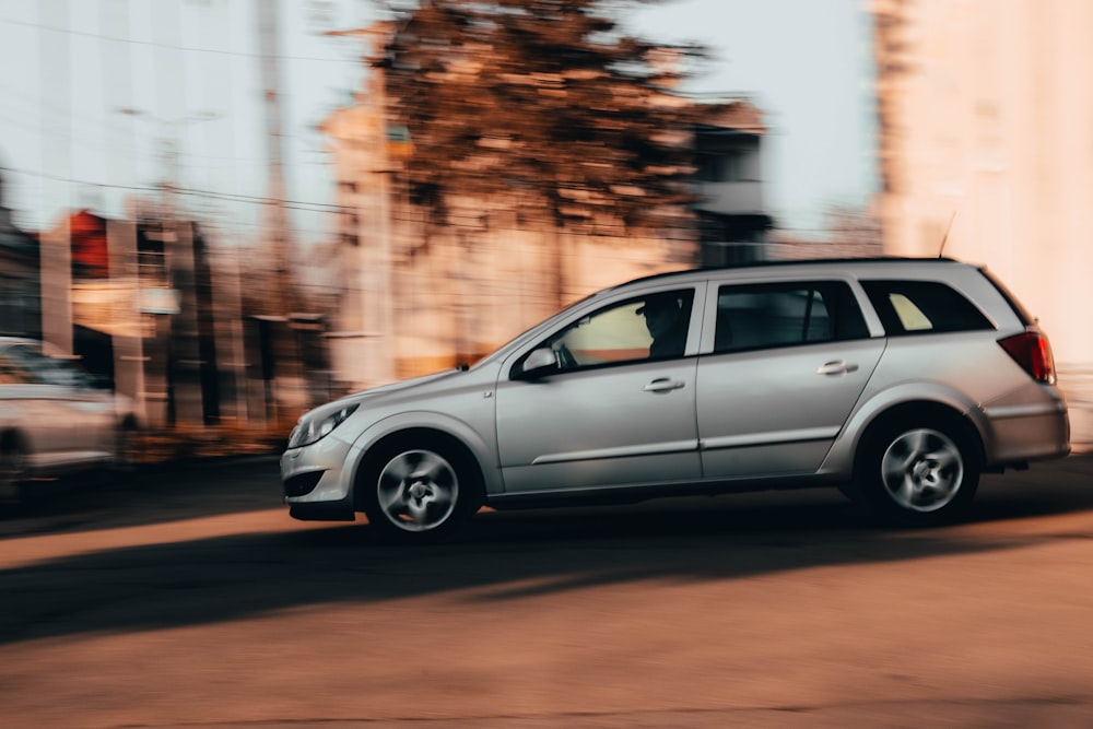 a silver car on a road