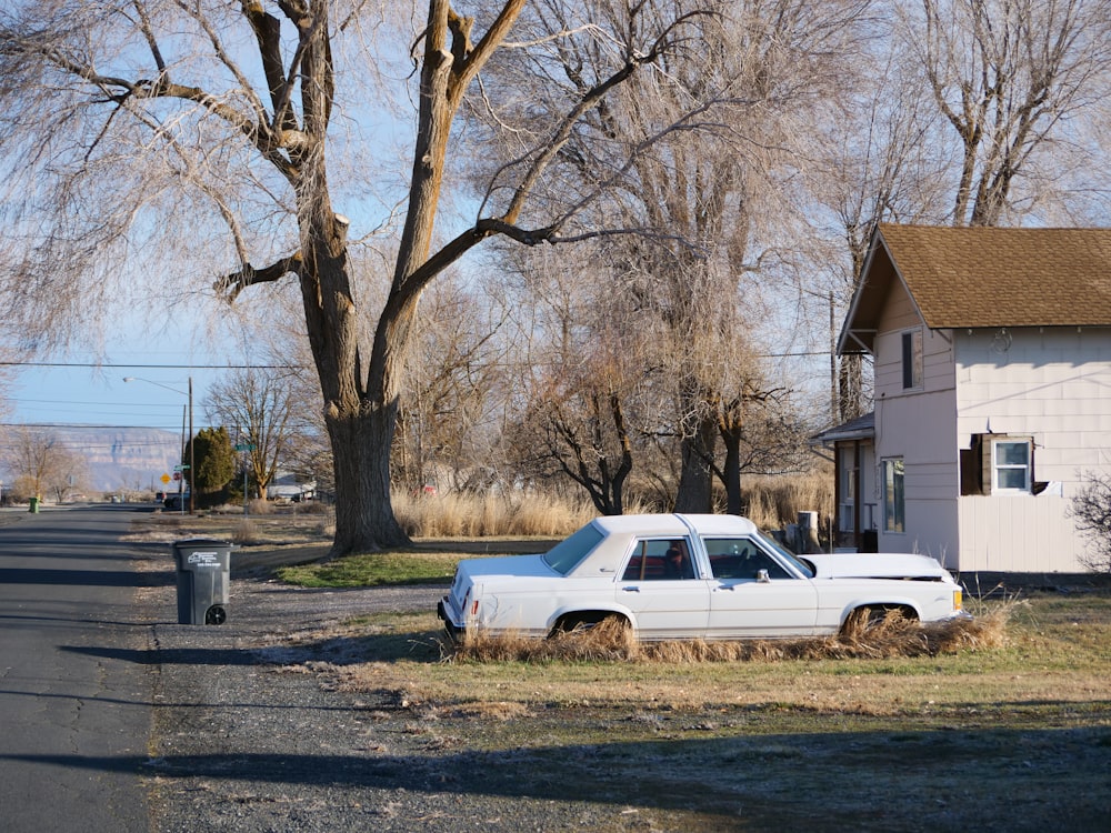 a white car parked on the side of a road