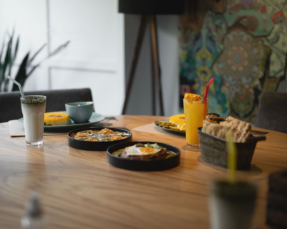 a table with plates of food and drinks on it