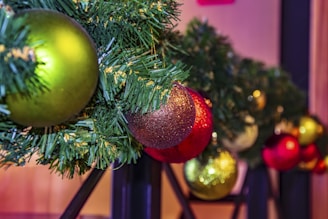 Close-up of sparkling ornaments and festive garlands arranged for a Christmas event.