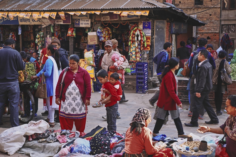 a group of people standing outside a shop