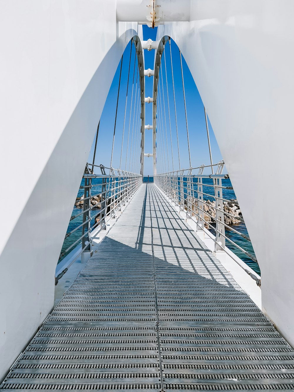 a long bridge with blue railings