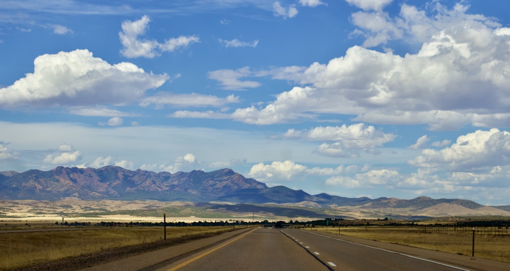 a road with mountains in the background