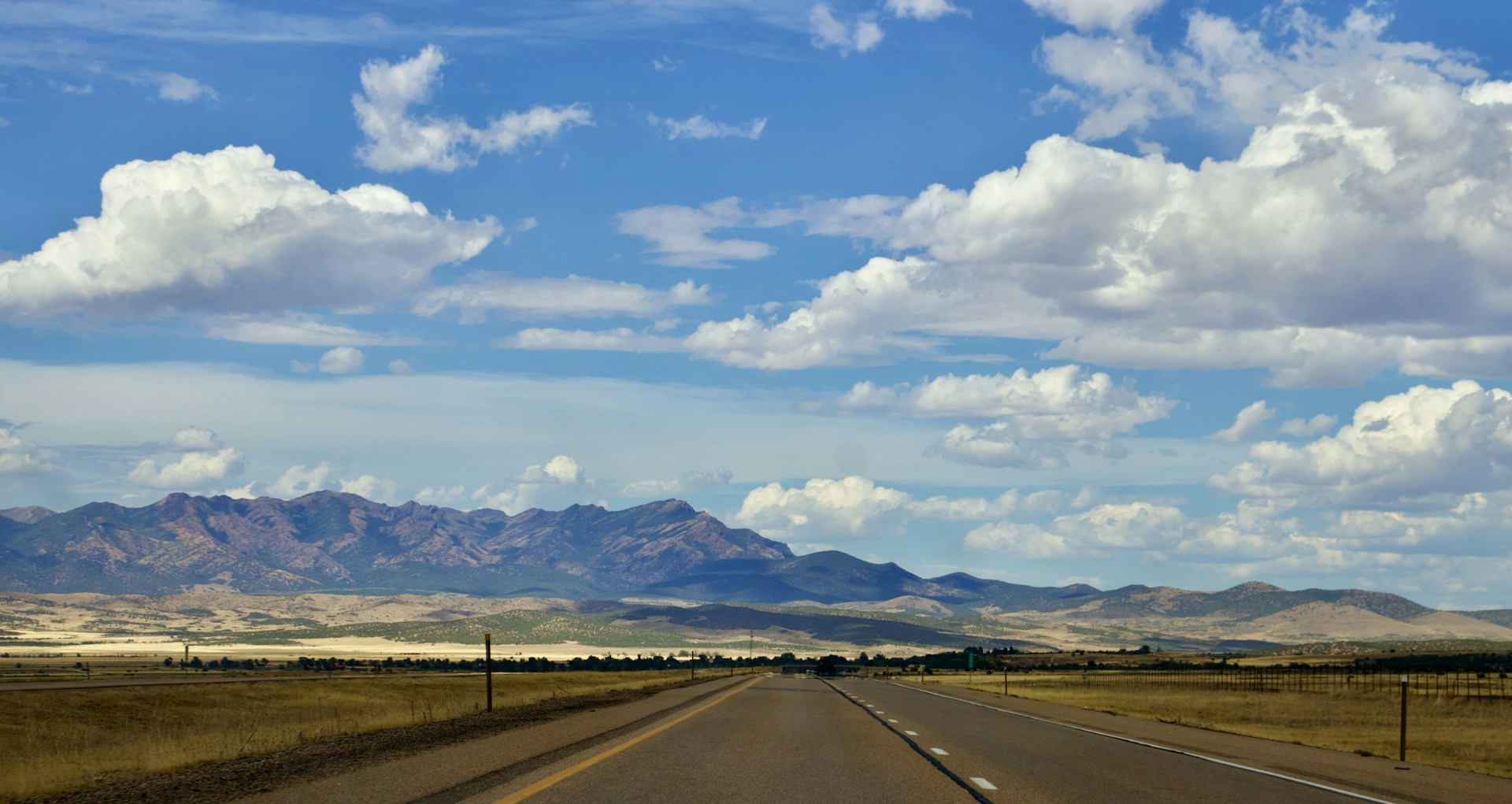 a road with mountains in the background