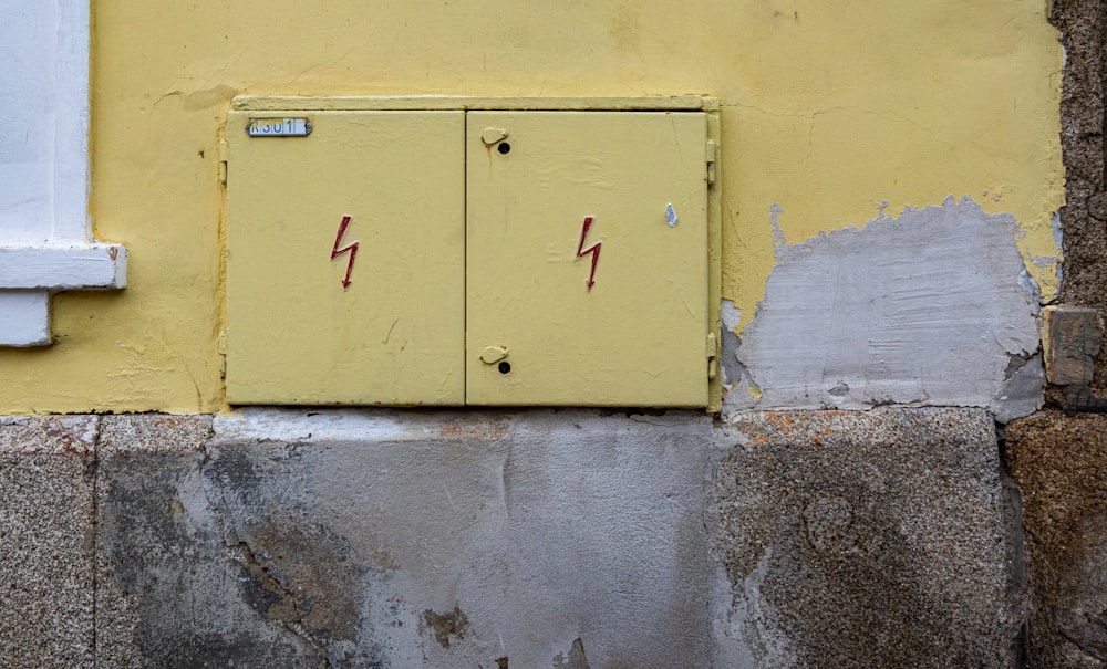 a yellow door with a red handle