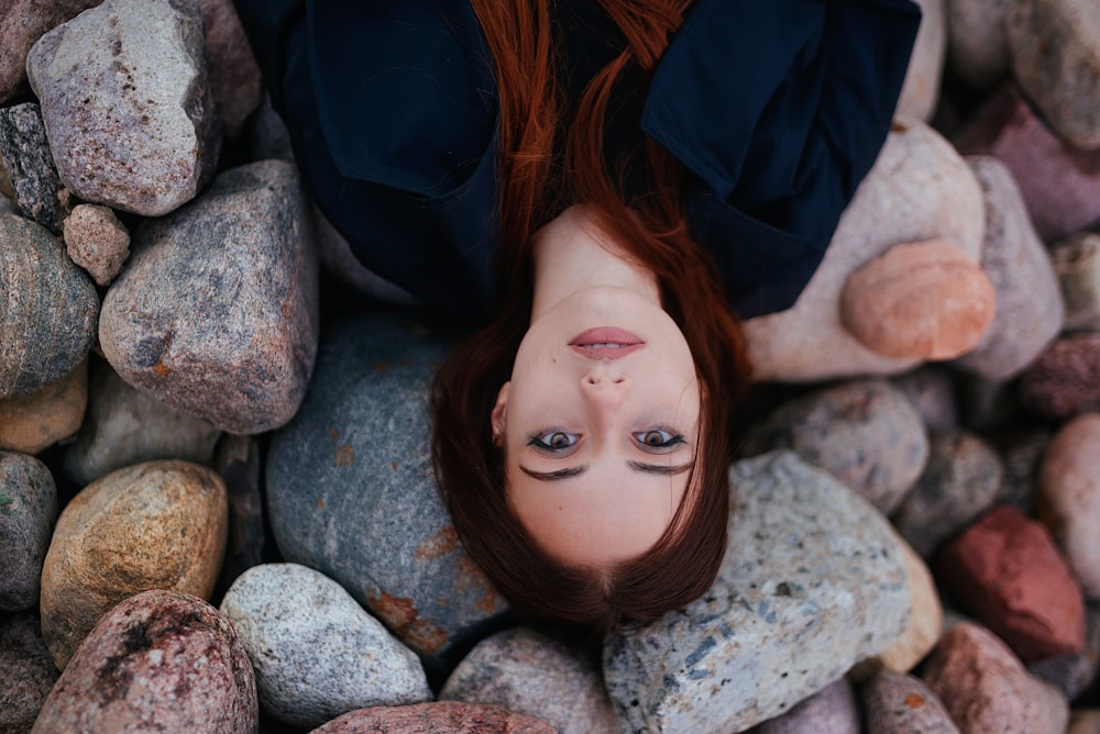 a person lying on rocks