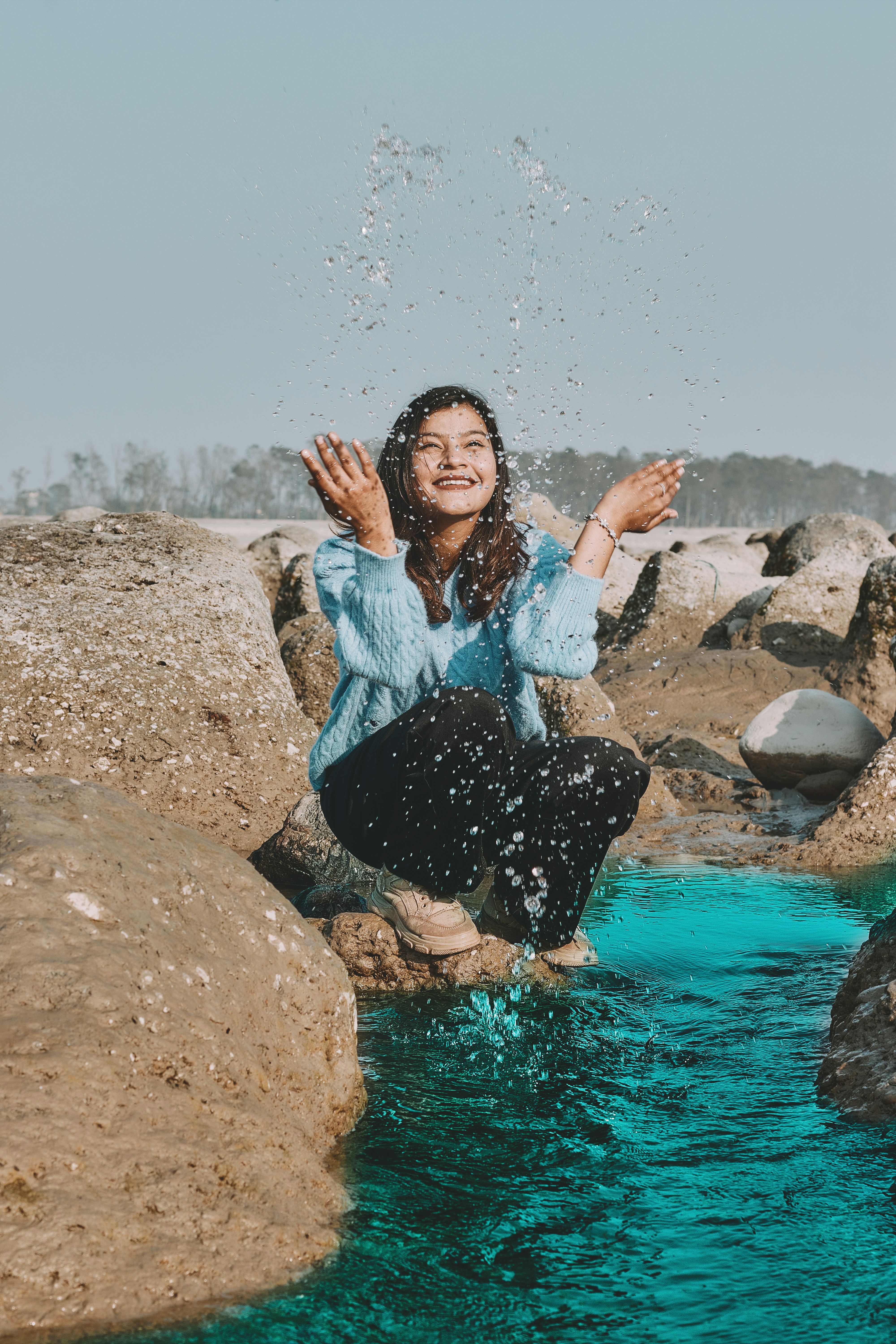 A person sitting on rocks photo – Free Flower Image on Unsplash