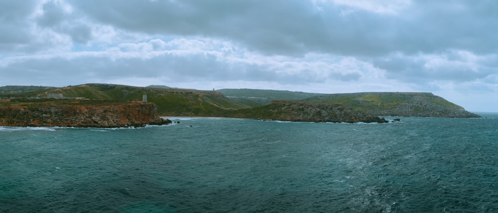 a body of water with land in the back