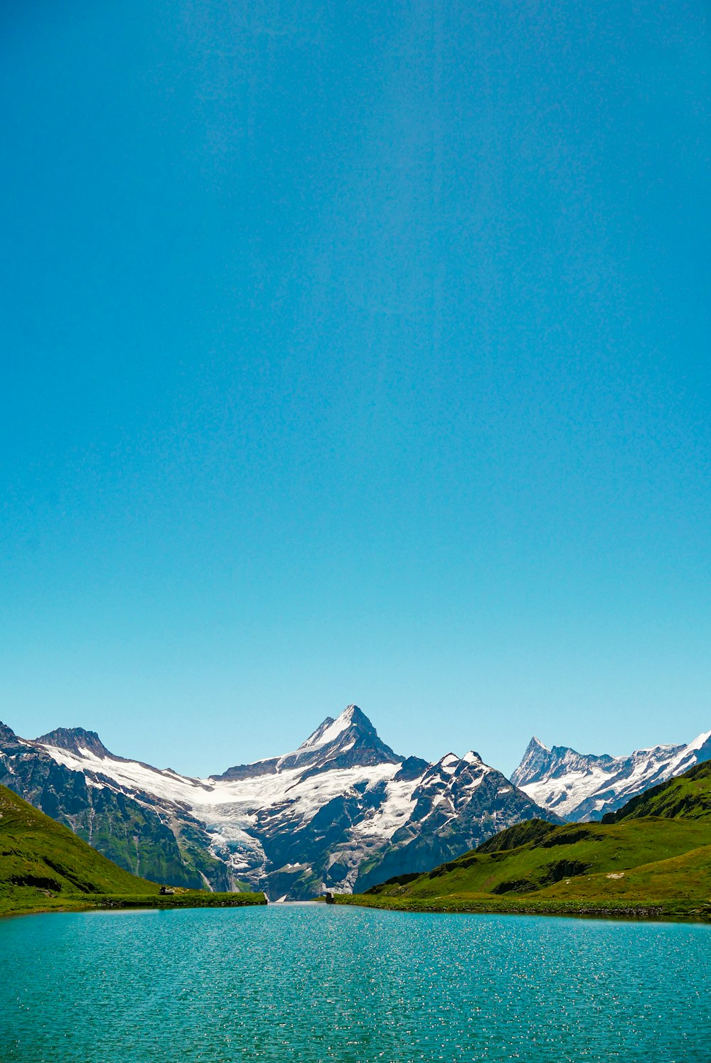 a body of water with mountains in the back