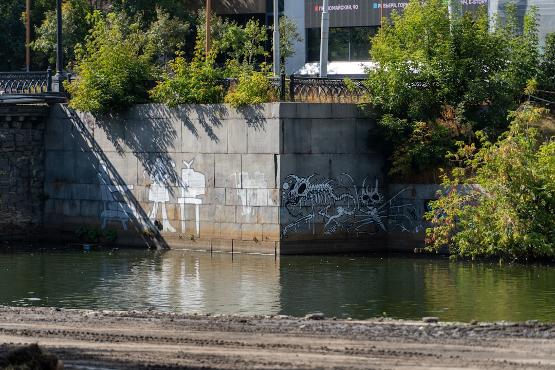 a concrete wall with graffiti,