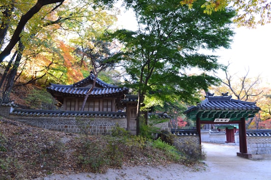 a japanese style building with a fence around it