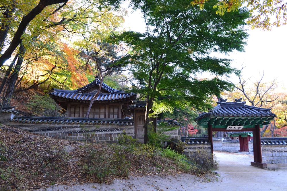 a japanese style building with a fence around it