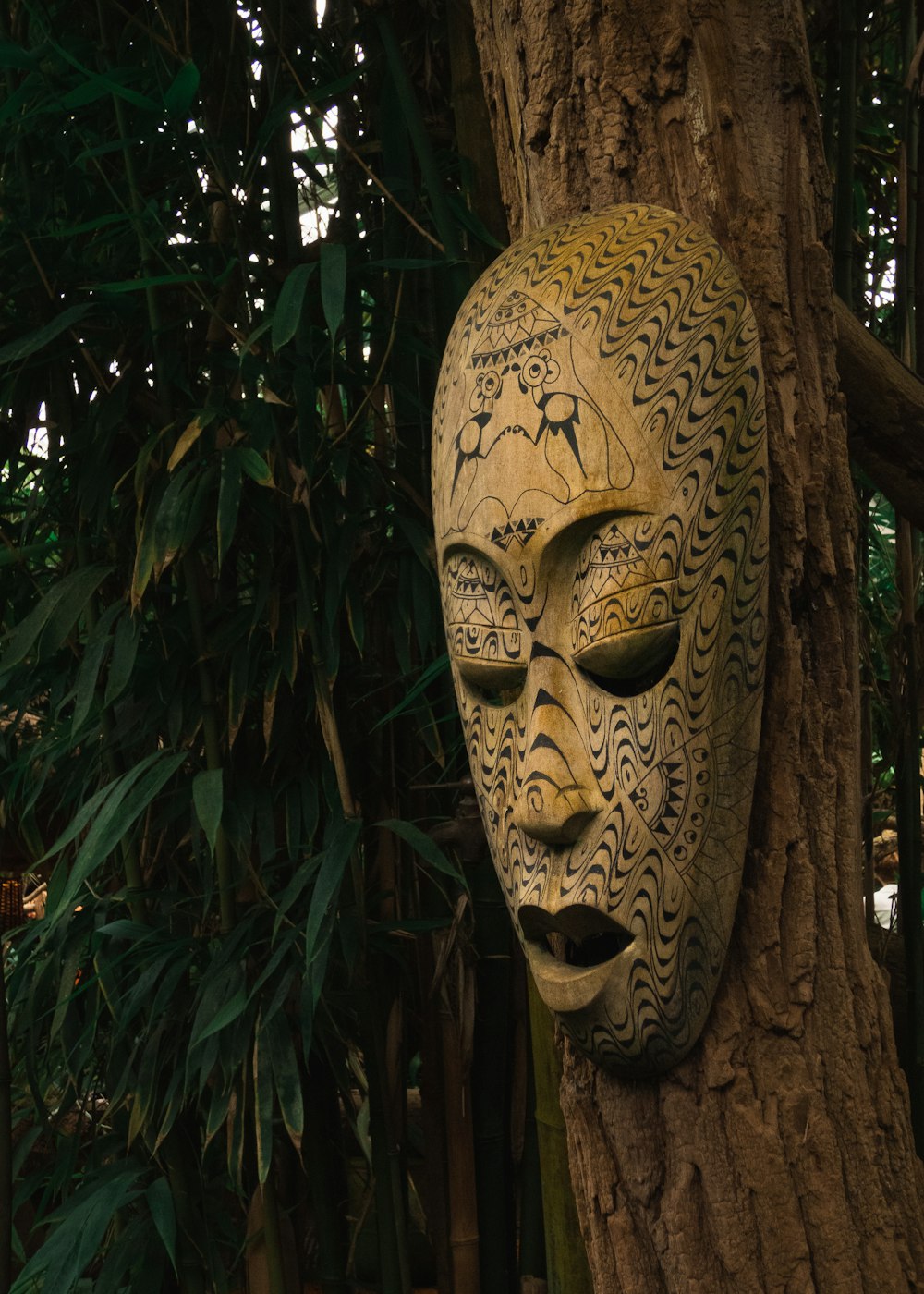 a tree trunk with a face painted on it