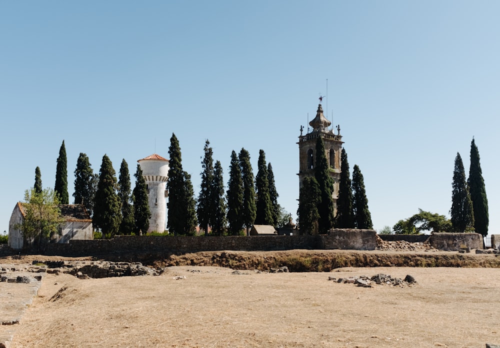 a stone structure with a tower and trees in the background