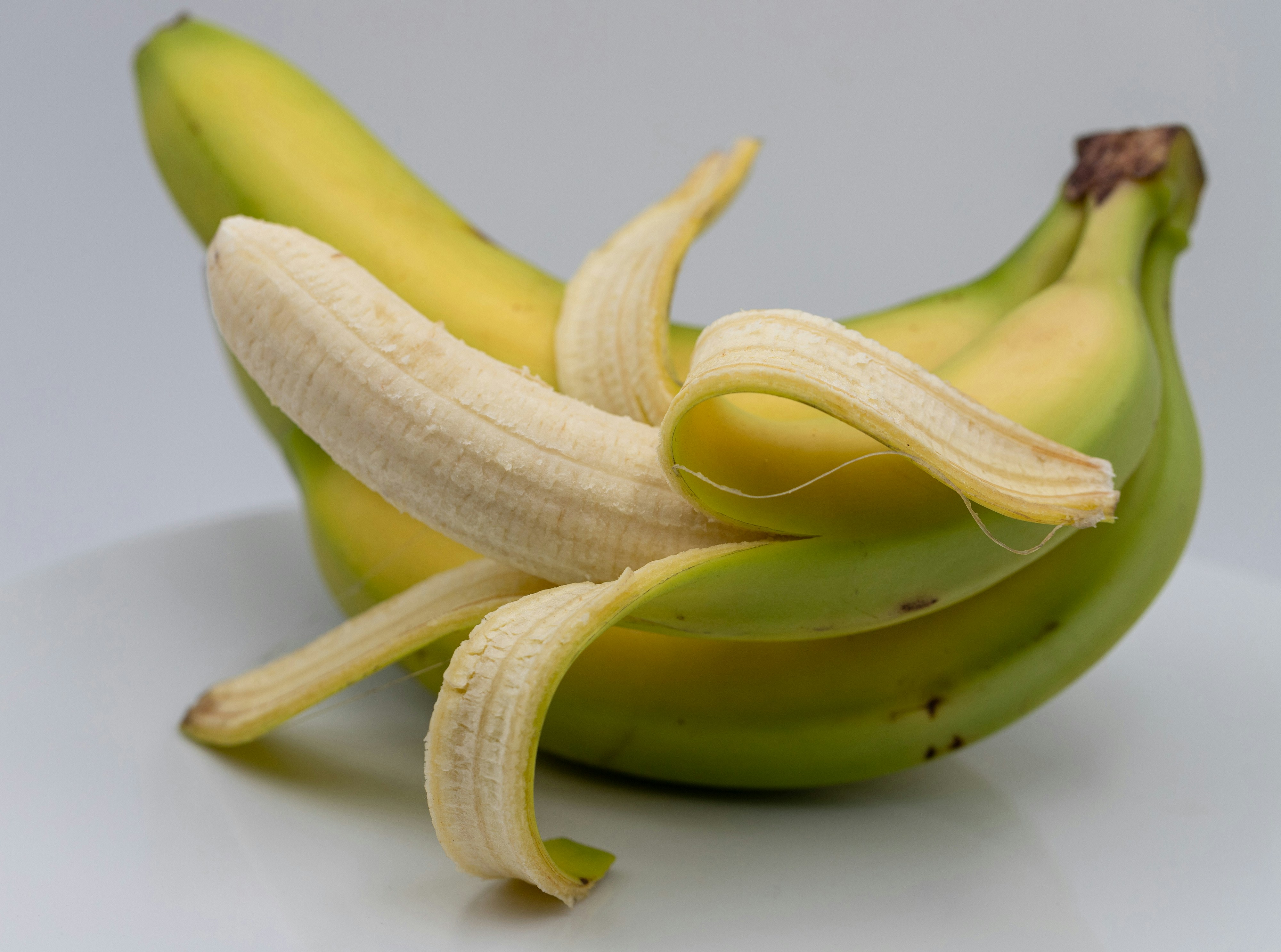 Healthy foods including bananas, almonds, and leafy greens