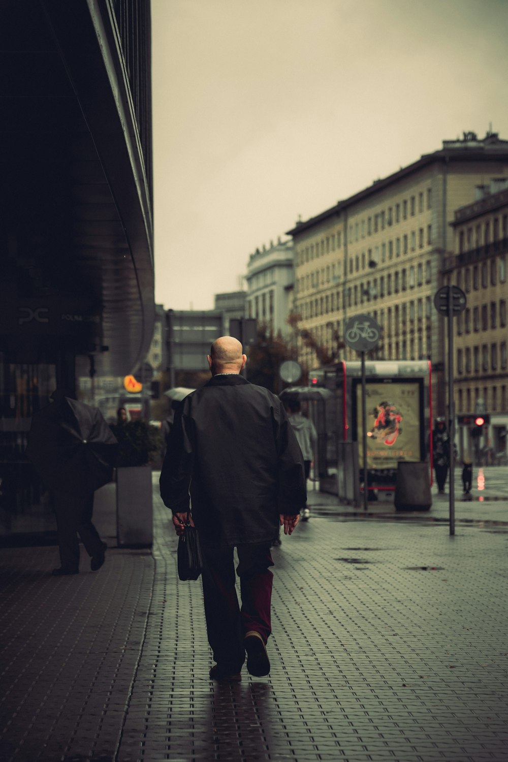 a man walking down a sidewalk