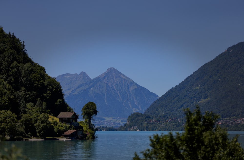 a lake with trees and mountains in the background