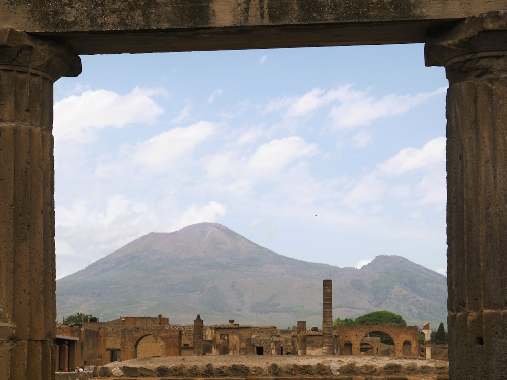 an old building with a mountain in the background