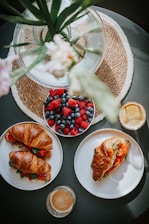A vibrant brunch table featuring specialty coffee, fresh fruits, and pastries.