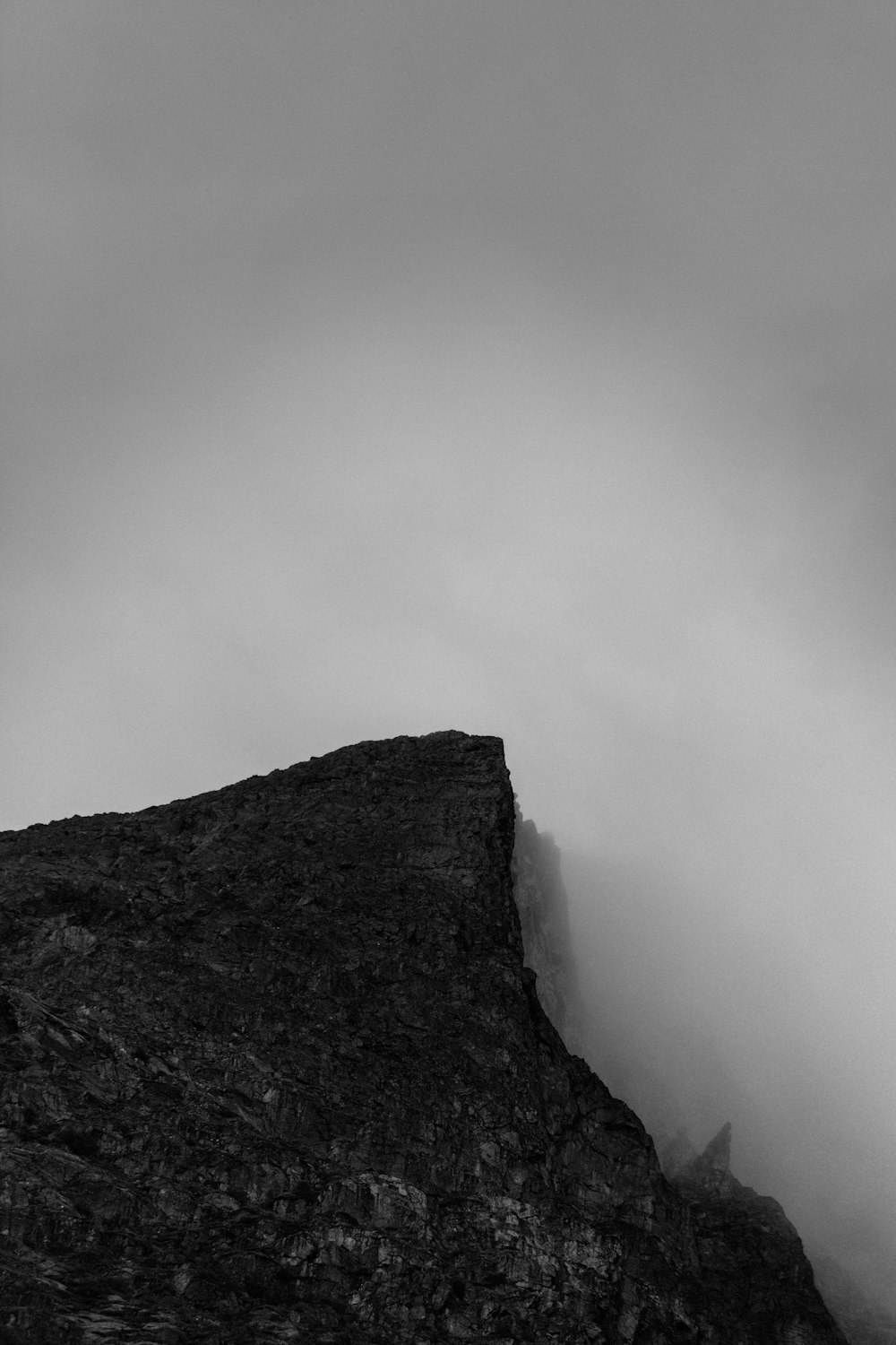 a mountain with a foggy sky