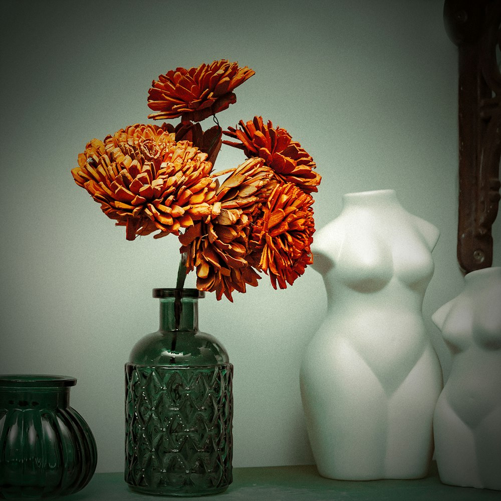 a vase with orange flowers