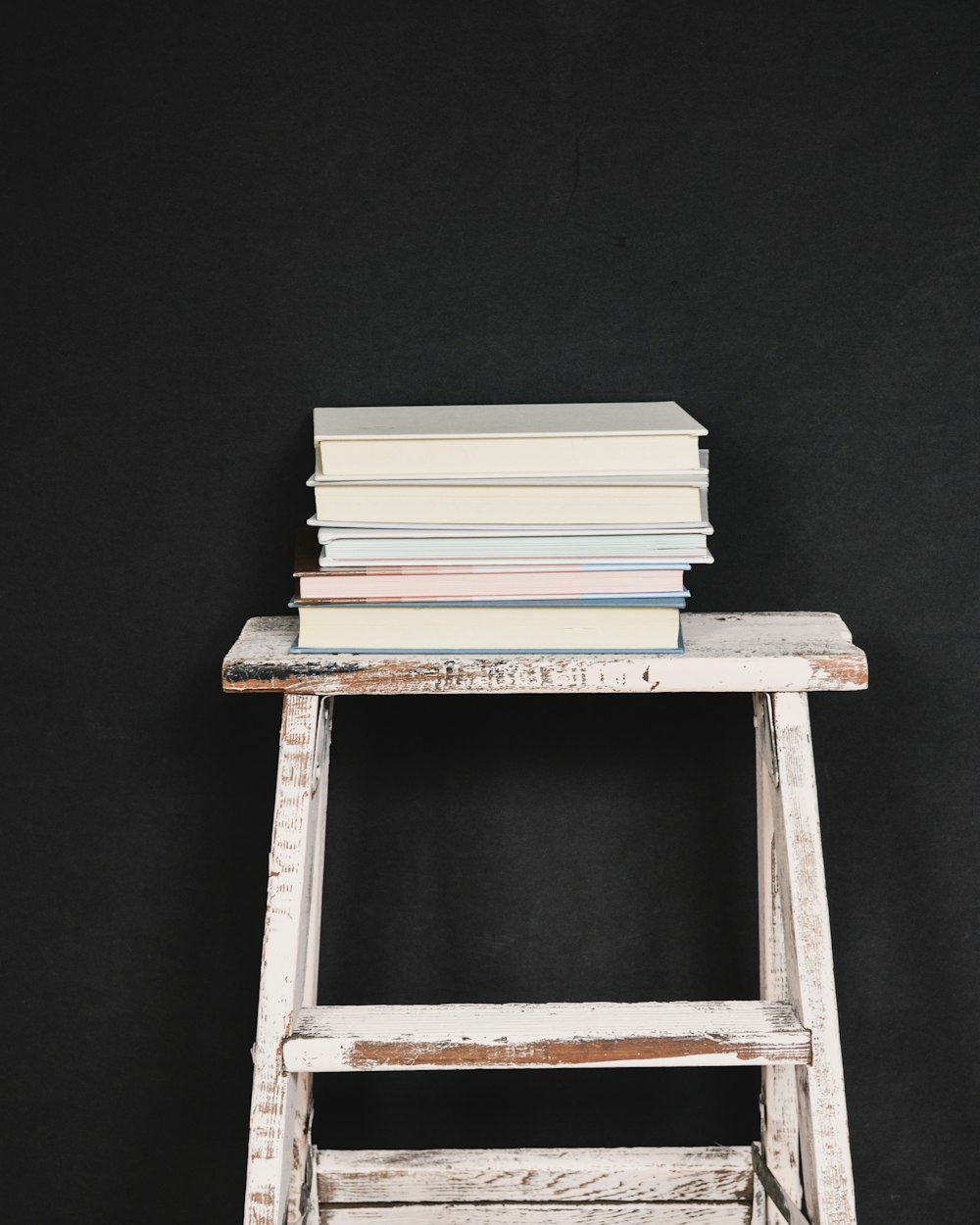 a stack of books in a wooden box