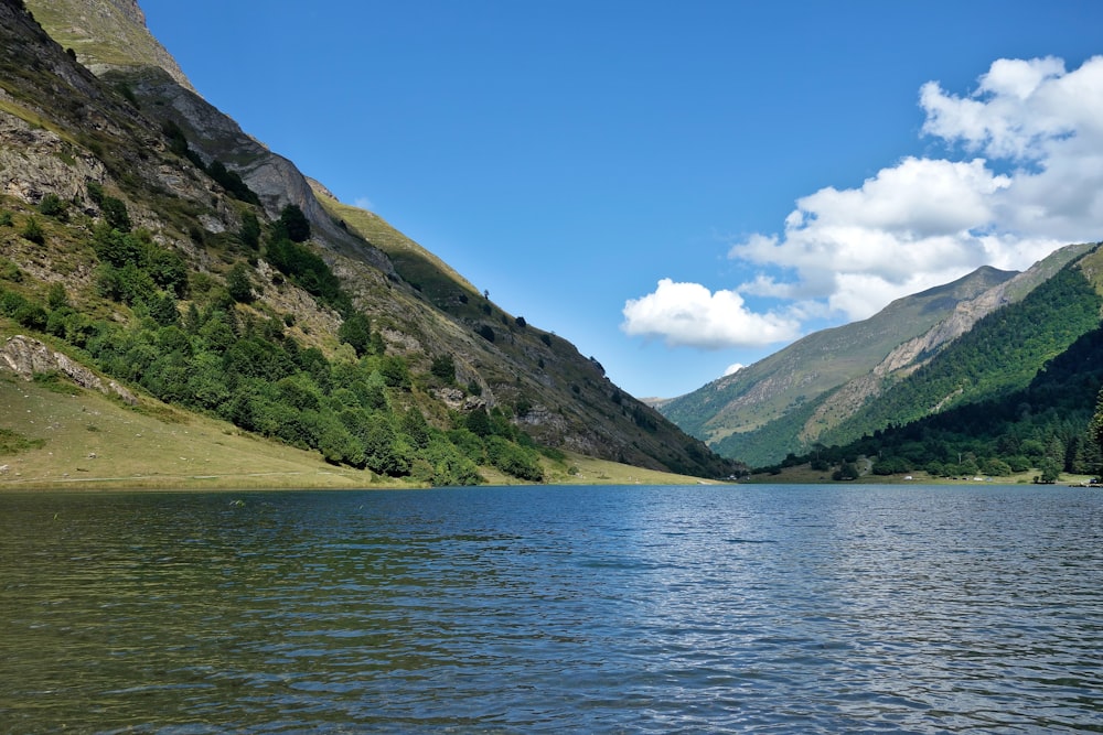 a body of water with mountains in the back