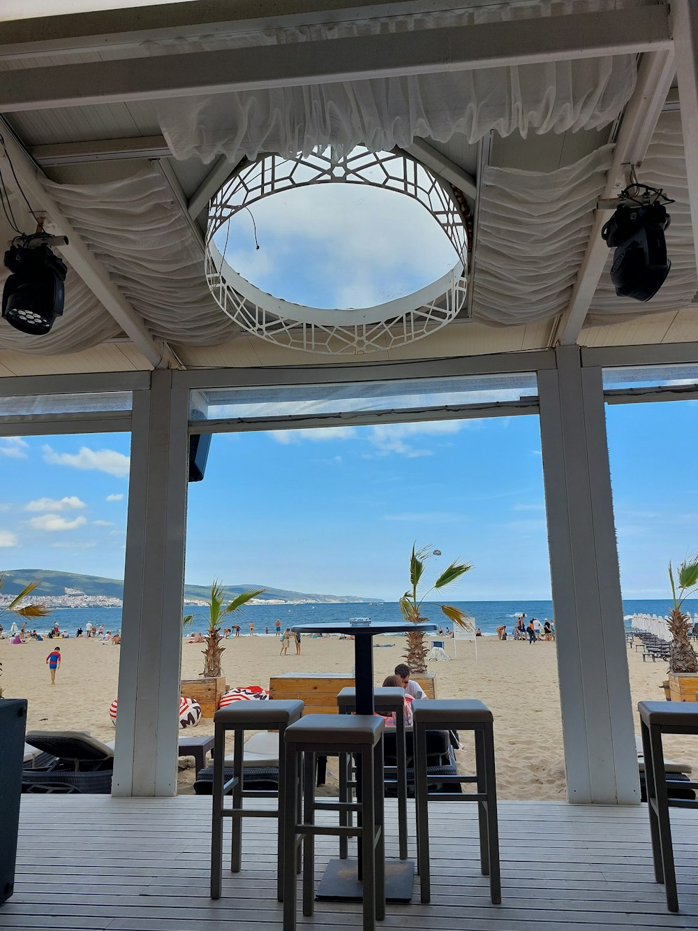 a group of people sitting at a table on a beach