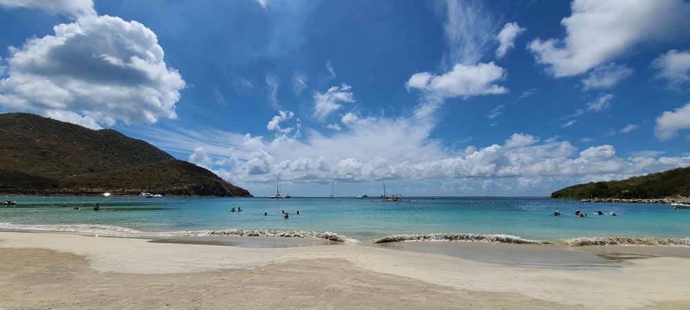 a beach with boats in the water