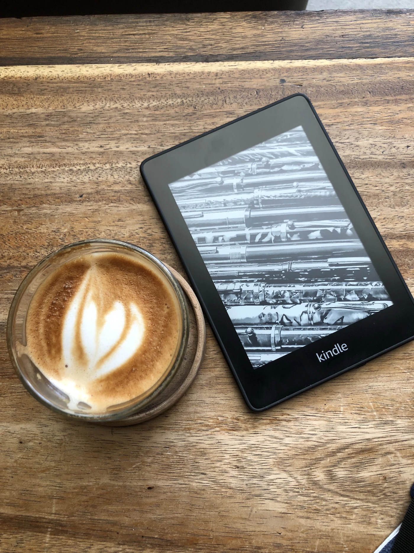 A tablet and a cup of coffee on a table