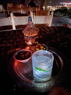 A lifestyle shot of the table used as a snack stand during a relaxed evening, with soft lighting and modern decor.
